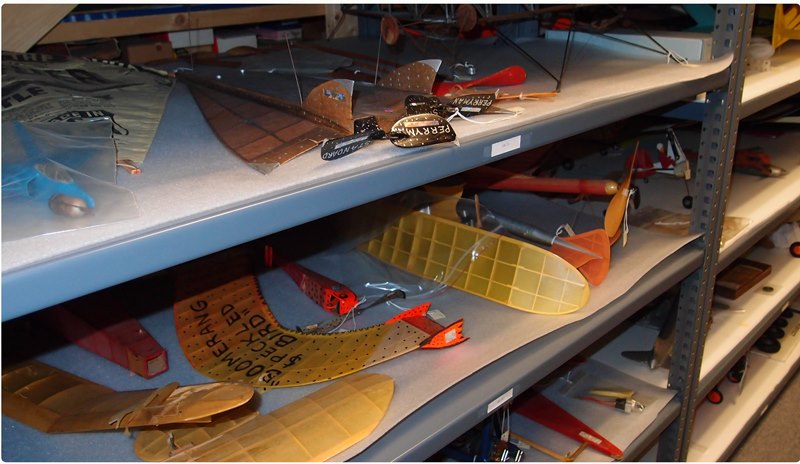 model airplanes and other artifacts on metal shelving in the collections space of the National Model Aviation Museum.jpg